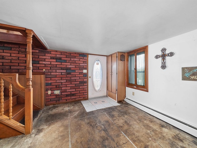 foyer featuring a baseboard radiator and brick wall