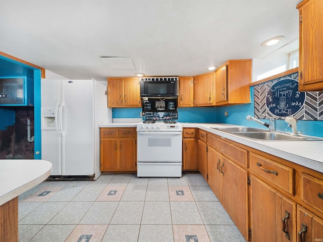 kitchen featuring decorative backsplash, light tile patterned flooring, white appliances, and sink