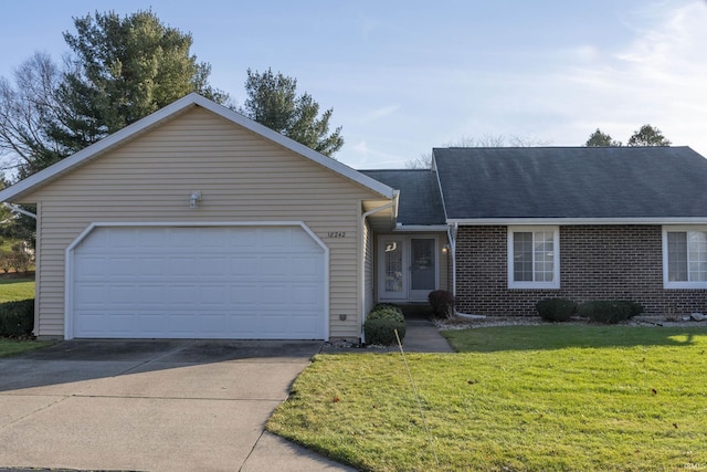 ranch-style home with a front yard and a garage