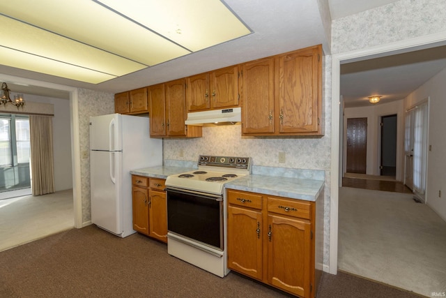 kitchen with carpet, a chandelier, and white appliances