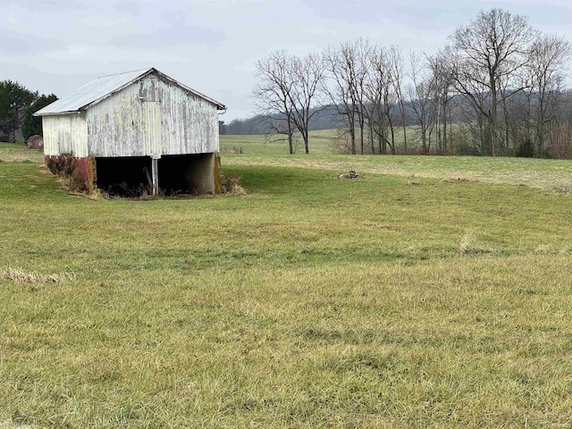 view of yard featuring a rural view and an outdoor structure