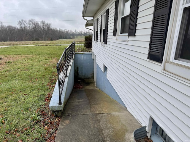 view of side of home with a yard