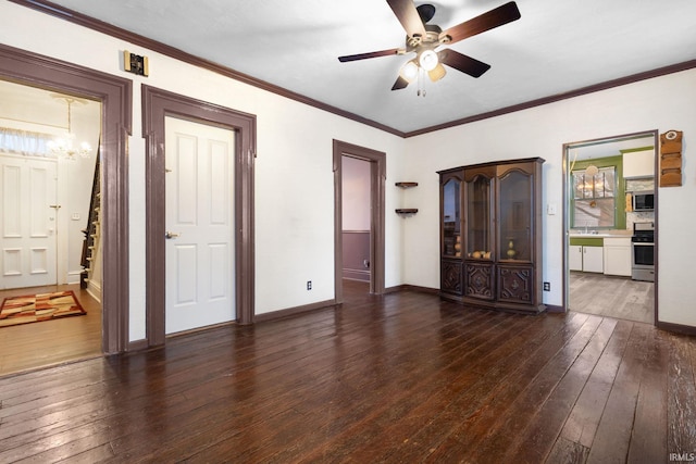 interior space featuring ceiling fan with notable chandelier, crown molding, and dark wood-type flooring