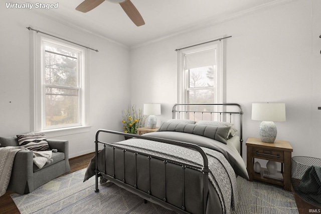 bedroom featuring ceiling fan, light hardwood / wood-style flooring, and crown molding