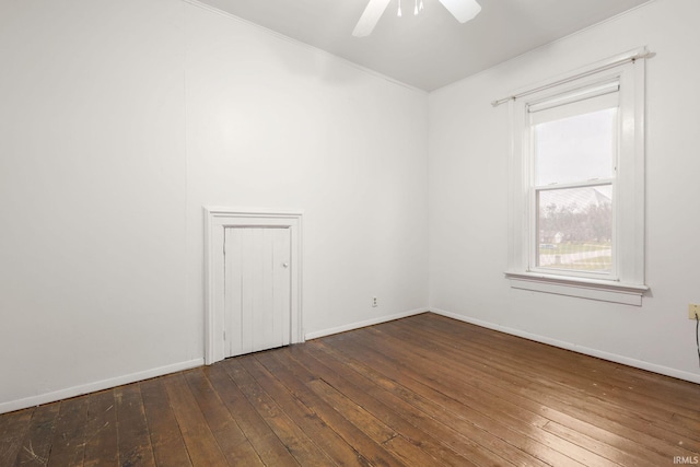 unfurnished room with ceiling fan and dark hardwood / wood-style flooring