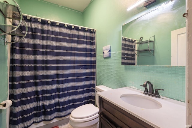 bathroom with vanity, toilet, walk in shower, and tile walls