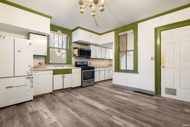 kitchen featuring decorative backsplash, stainless steel appliances, white cabinetry, and light hardwood / wood-style flooring