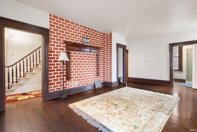 unfurnished living room with dark wood-type flooring