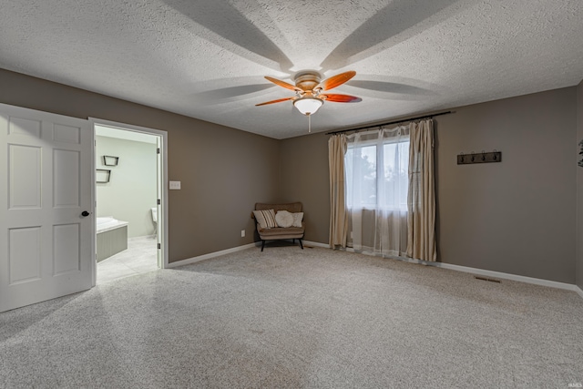 unfurnished room featuring a textured ceiling and ceiling fan