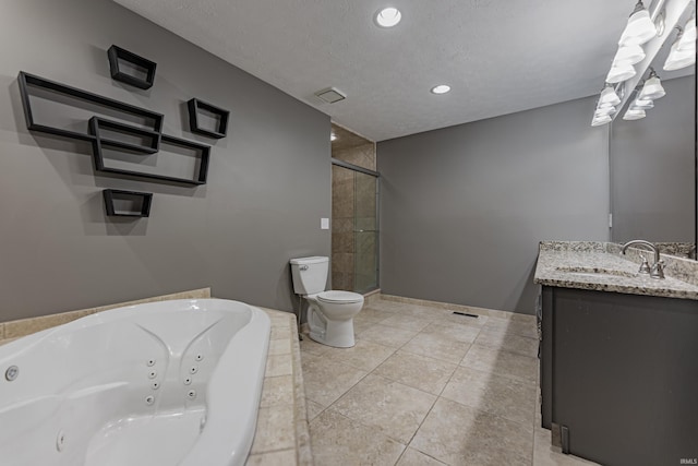 bathroom featuring tile patterned flooring, a textured ceiling, toilet, a bathtub, and vanity