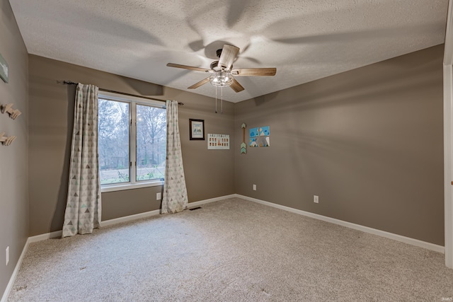 carpeted empty room with a textured ceiling and ceiling fan