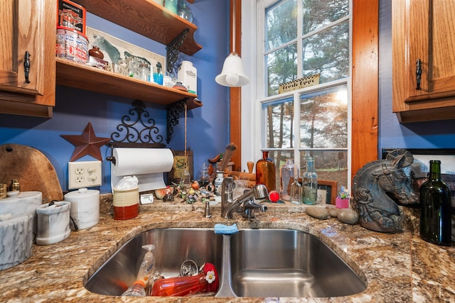 kitchen with light stone countertops and sink