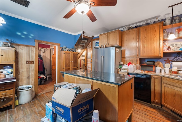 kitchen with light wood-type flooring, black dishwasher, high quality fridge, ornamental molding, and a kitchen island