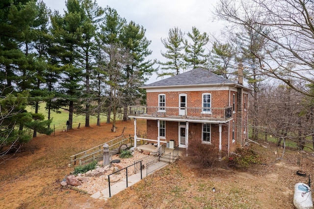 rear view of house featuring a balcony