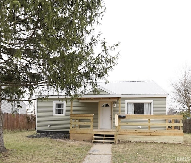 view of front of home with a front lawn and a deck