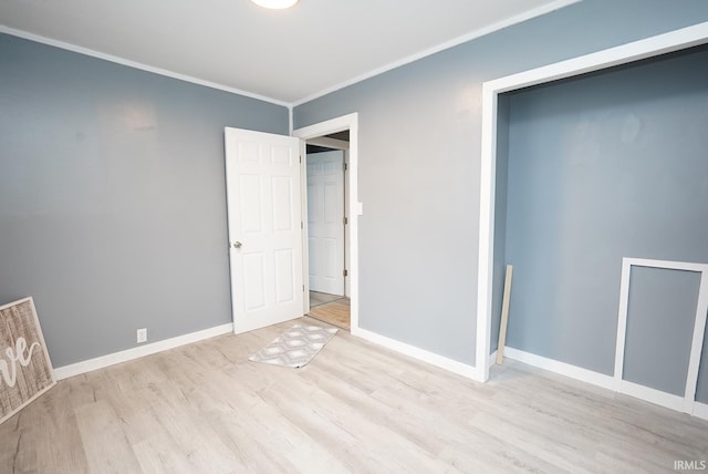 unfurnished bedroom featuring light wood-type flooring and ornamental molding