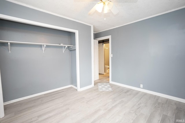 unfurnished bedroom with a closet, ceiling fan, ornamental molding, and light hardwood / wood-style floors