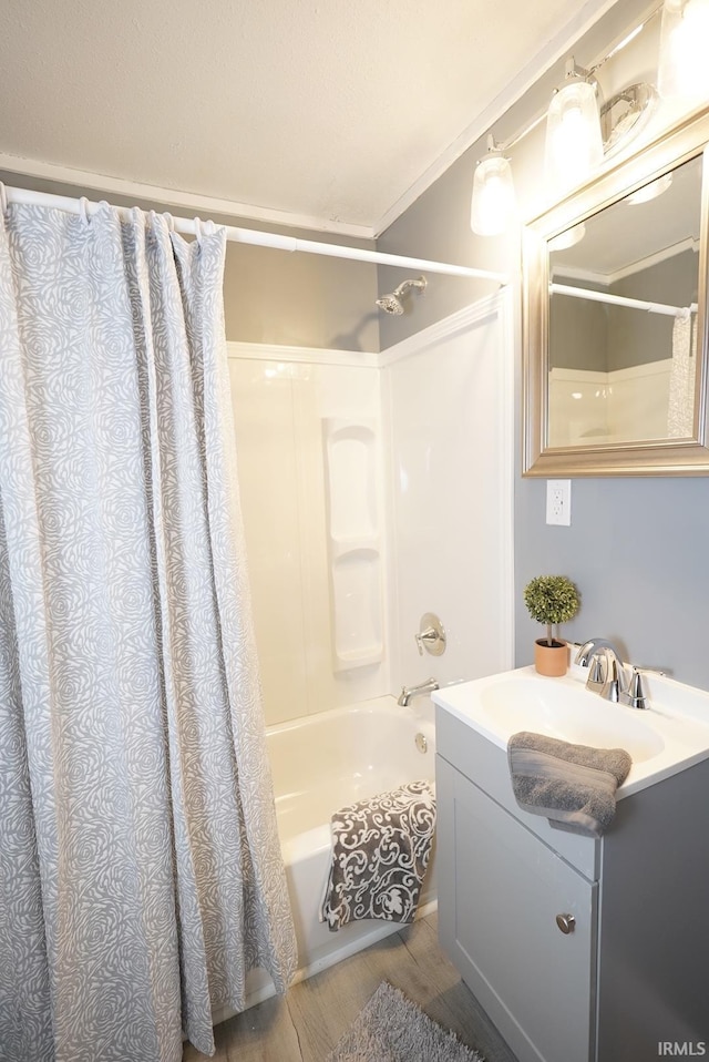 bathroom featuring vanity, hardwood / wood-style flooring, shower / tub combo with curtain, and crown molding