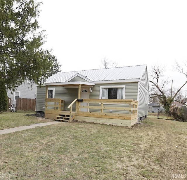 view of front facade featuring a front yard and a deck