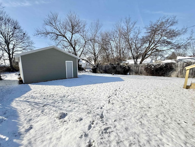 yard covered in snow featuring an outbuilding