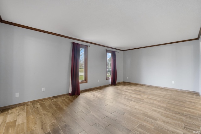 spare room featuring light hardwood / wood-style floors and crown molding