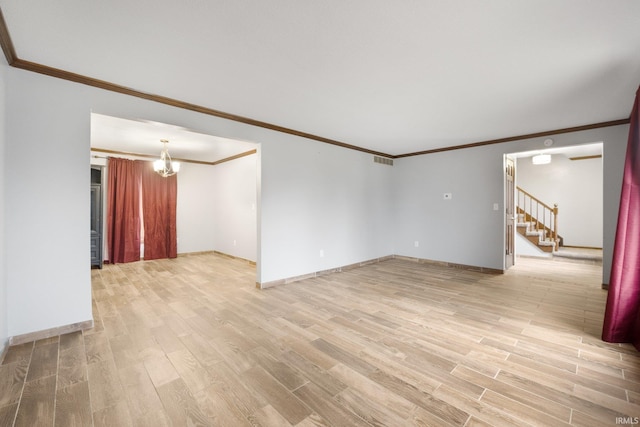 unfurnished room featuring light hardwood / wood-style flooring, an inviting chandelier, and ornamental molding