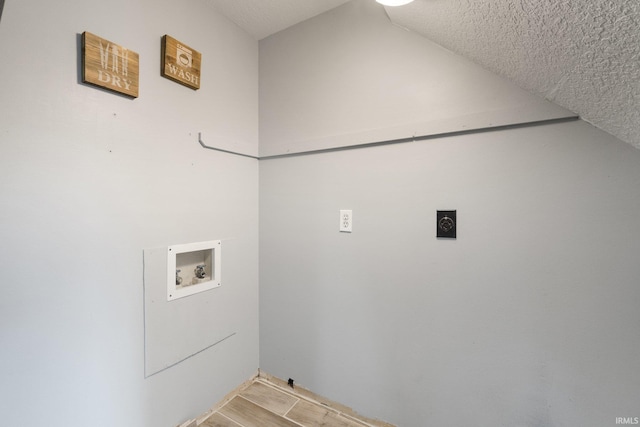 laundry room featuring washer hookup, a textured ceiling, and electric dryer hookup