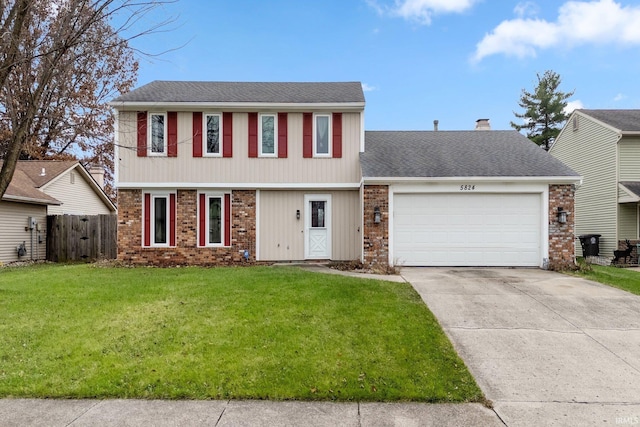 view of front of property featuring a garage and a front yard