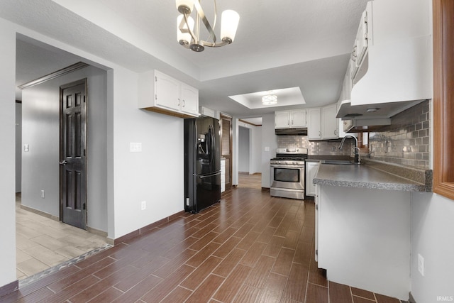 kitchen featuring stainless steel range, black fridge with ice dispenser, white cabinetry, and sink