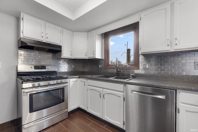 kitchen with white cabinets, decorative backsplash, sink, and appliances with stainless steel finishes