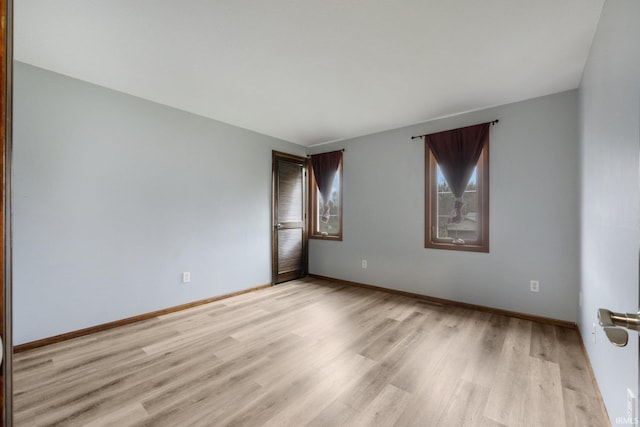 unfurnished room with light hardwood / wood-style flooring