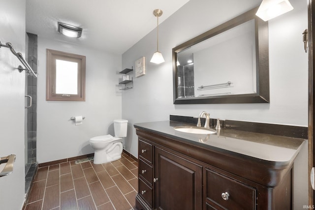 bathroom featuring vanity, toilet, and walk in shower