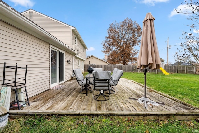 deck featuring a playground and a yard