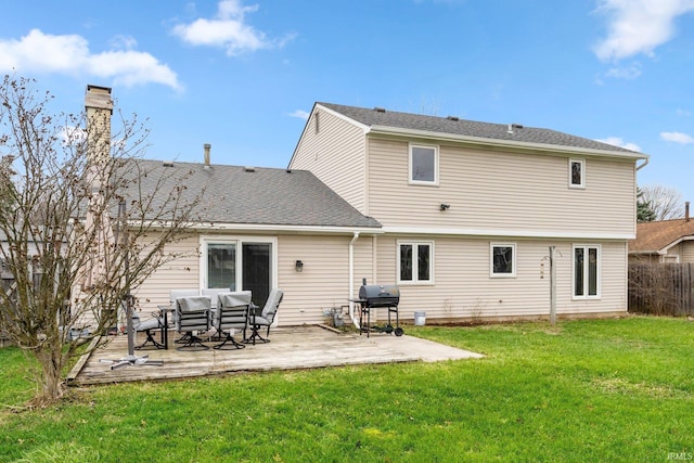 rear view of house with a yard and a patio area