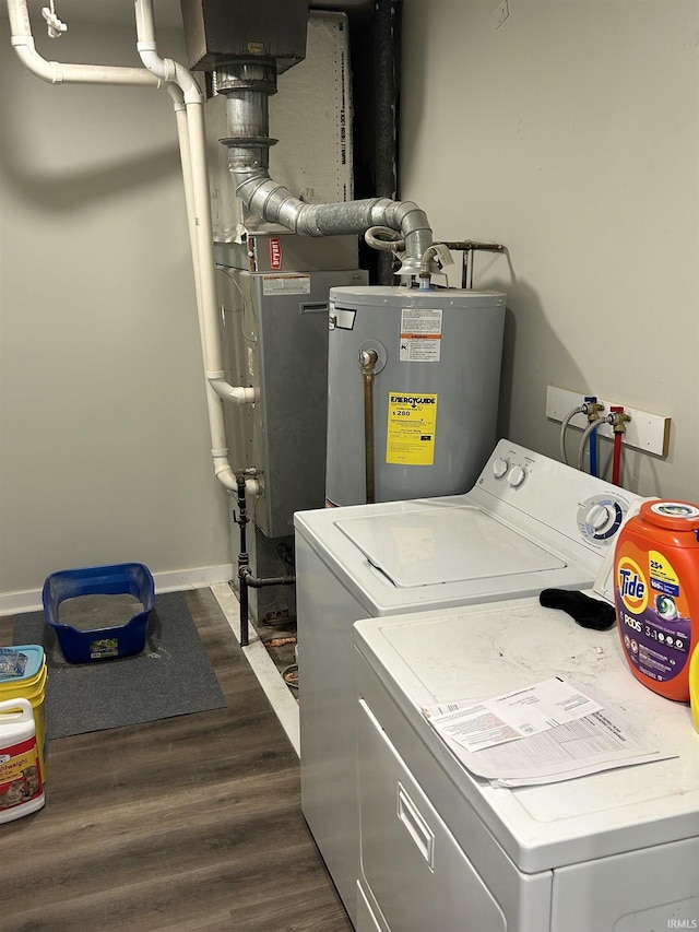 laundry room featuring dark hardwood / wood-style flooring, electric water heater, and separate washer and dryer