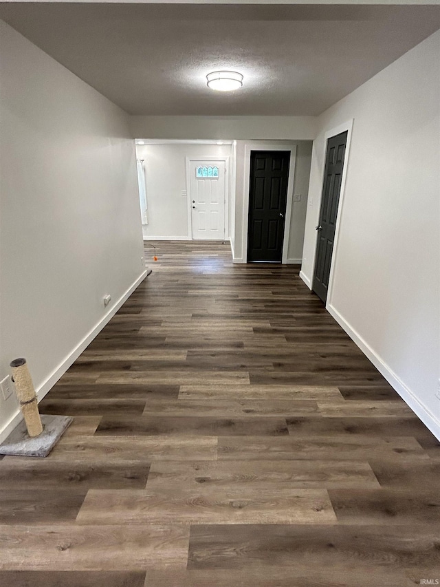 entryway featuring a textured ceiling and dark wood-type flooring