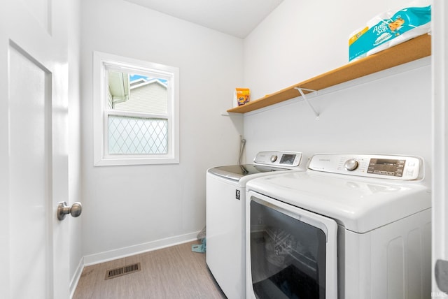 washroom featuring independent washer and dryer and light wood-type flooring