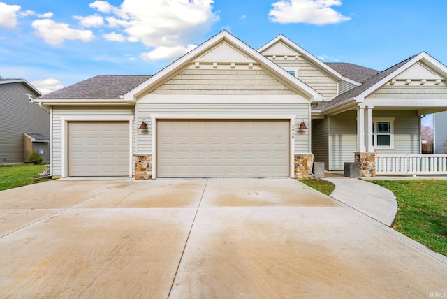 craftsman house with covered porch and a garage