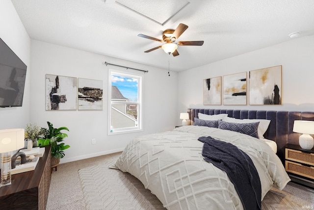 bedroom with carpet flooring, a textured ceiling, and ceiling fan