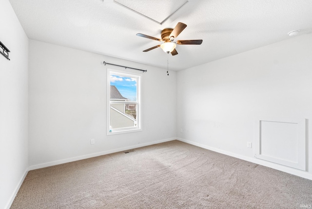 empty room featuring ceiling fan, carpet floors, and a textured ceiling