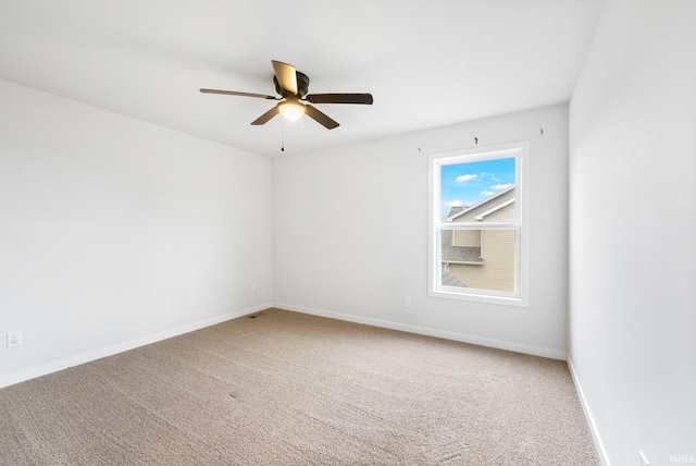 spare room featuring carpet flooring and ceiling fan