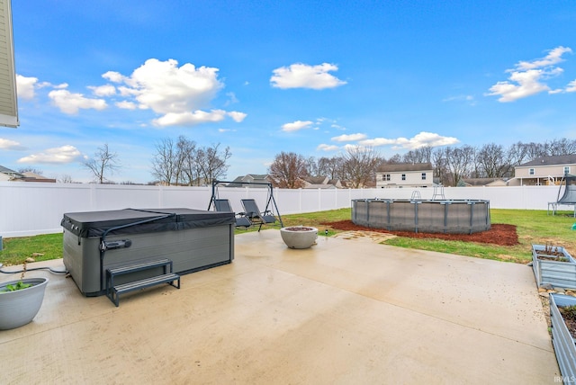 view of patio / terrace with a swimming pool with hot tub