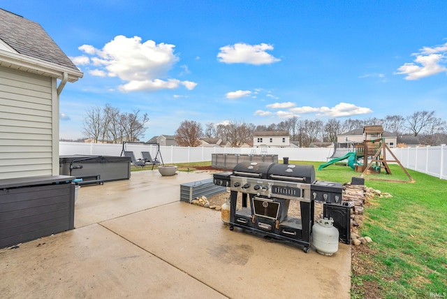 view of patio / terrace with a playground, grilling area, and a hot tub