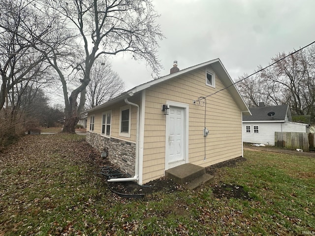 back of house with a lawn