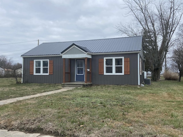 view of front of house with cooling unit and a front yard