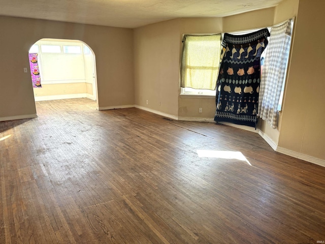 empty room featuring dark wood-type flooring