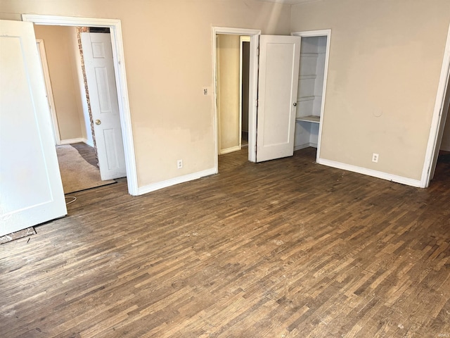 unfurnished bedroom featuring dark hardwood / wood-style floors