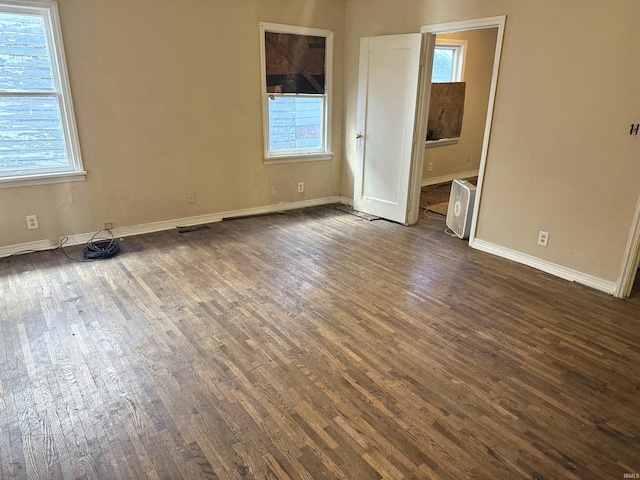 unfurnished room featuring dark hardwood / wood-style flooring