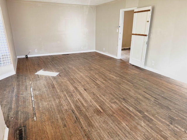 unfurnished room with dark hardwood / wood-style floors