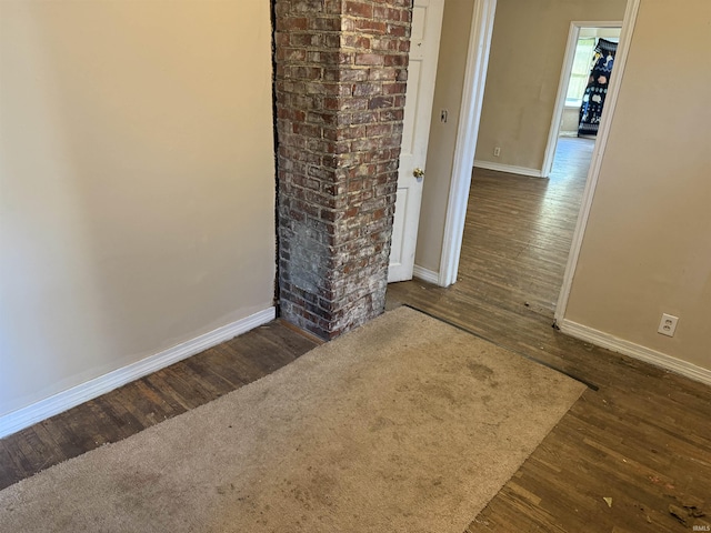 spare room with dark hardwood / wood-style flooring